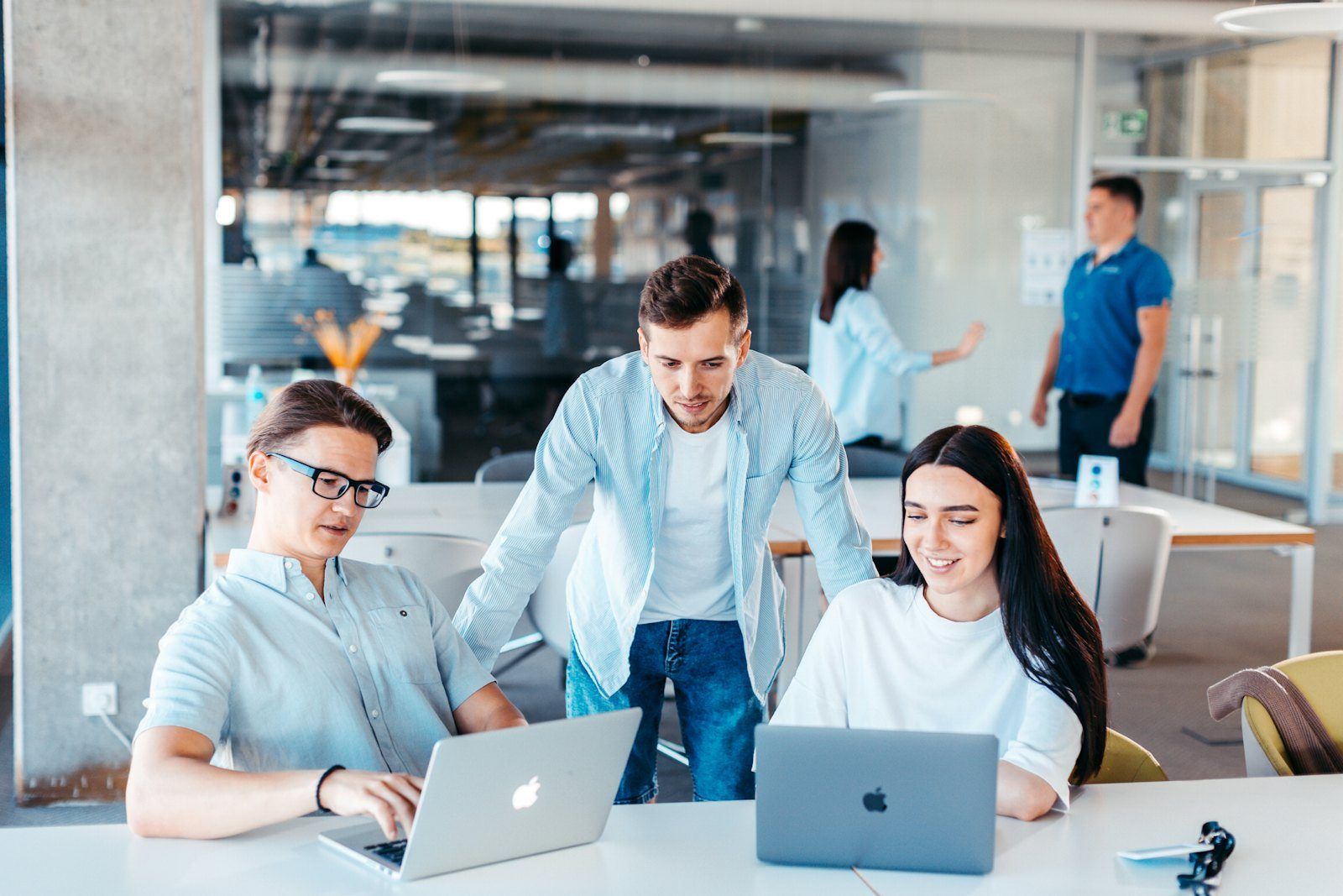 Three colleagues working together at their laptops